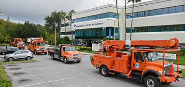 Trucks in front of utility headquarters building