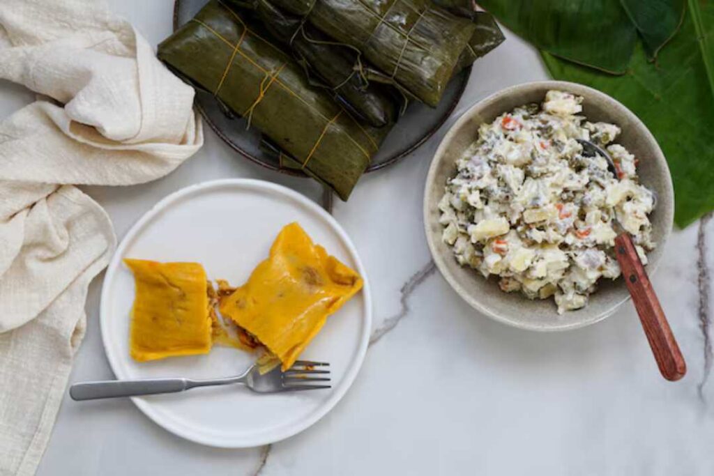 Hallaca in a plate and a bowl of chicken salad