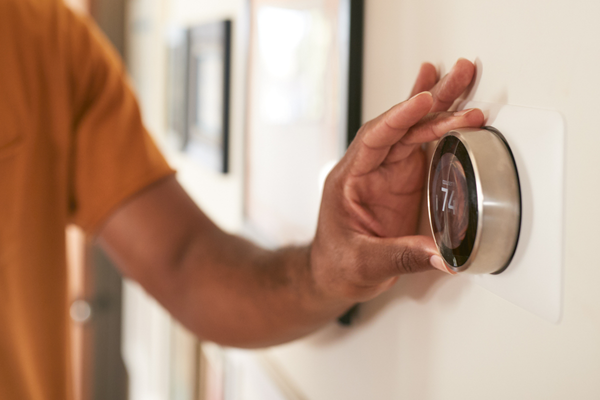Hand of a man adjusting thermostat