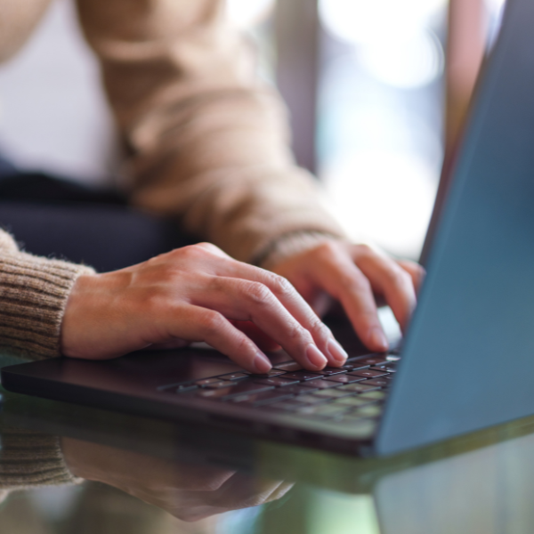 Close up of hands typing on a keyboard